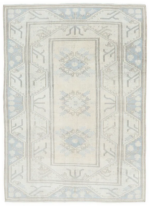 Full overhead view of the ivory and blue vintage Anatolian area rug