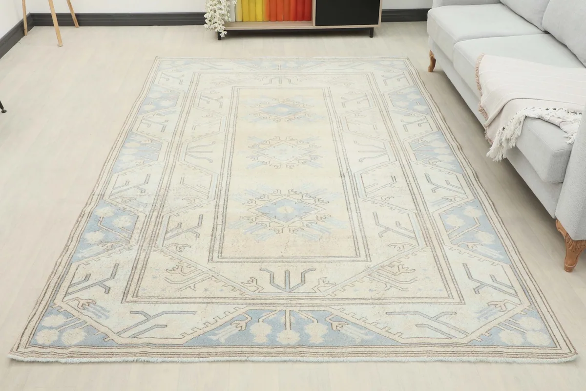 Overhead view of the ivory and blue rug in a living room, showcasing its full size