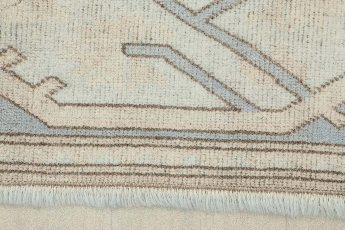 Detail of the rug's border, fringe, and the hand-knotted wool pile