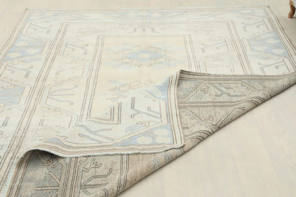 View of the rug with a corner folded back, showing the back and front details
