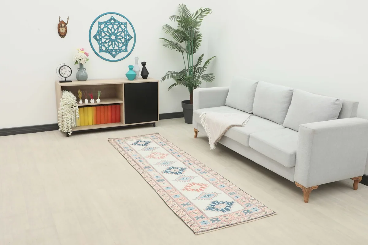 Runner rug placed in a modern living room setting, showing its scale next to a sofa and cabinet.