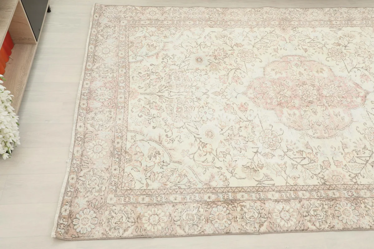 Another angled view of the ivory rug, focusing on the overall pattern and soft color palette.