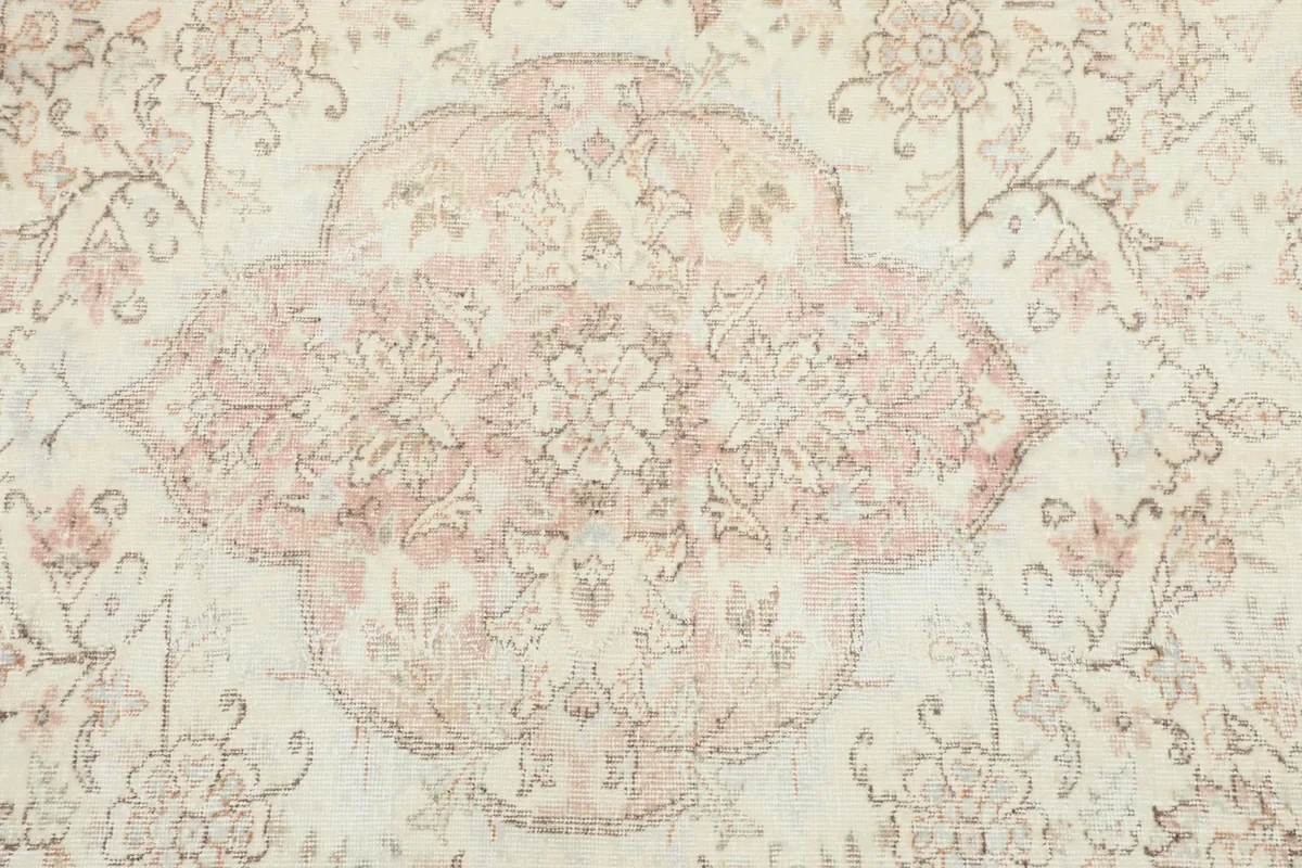 Detailed view of the central rose medallion with intricate floral designs.