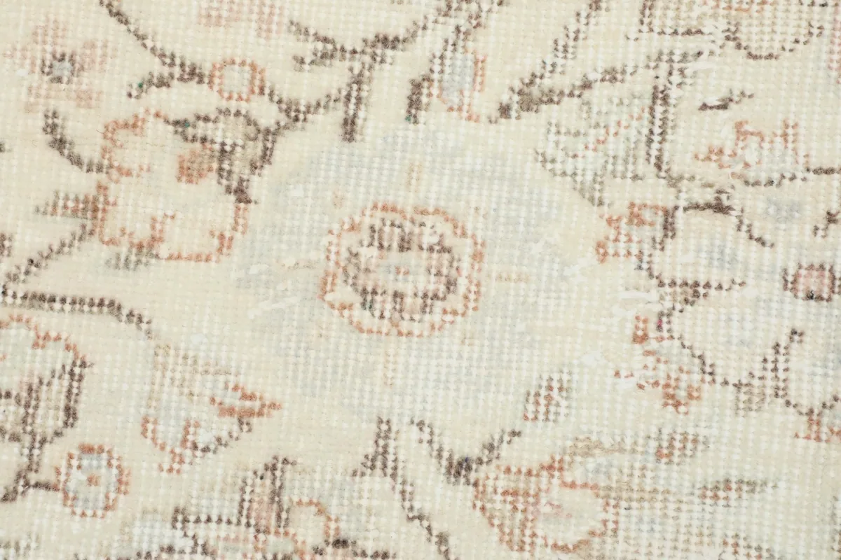 Close-up of the rug's low pile, showing the texture and subtle color variations of the wool.