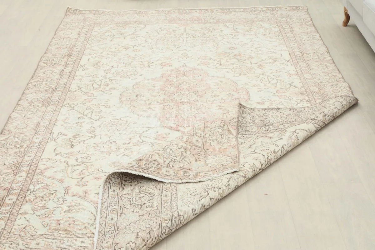 The rug partially folded to show its flexibility and the consistent pattern from edge to center.