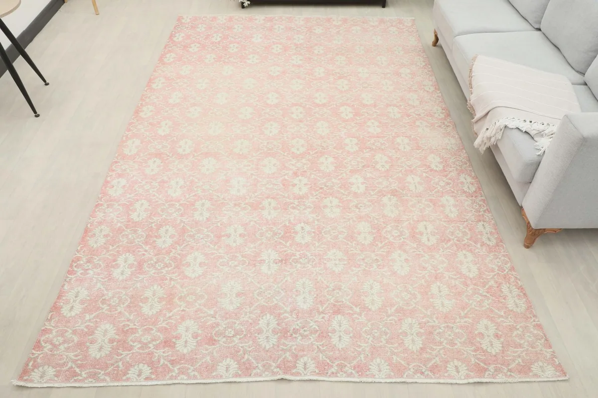 Overhead room view of the large pink and ivory vintage rug in a spacious setting