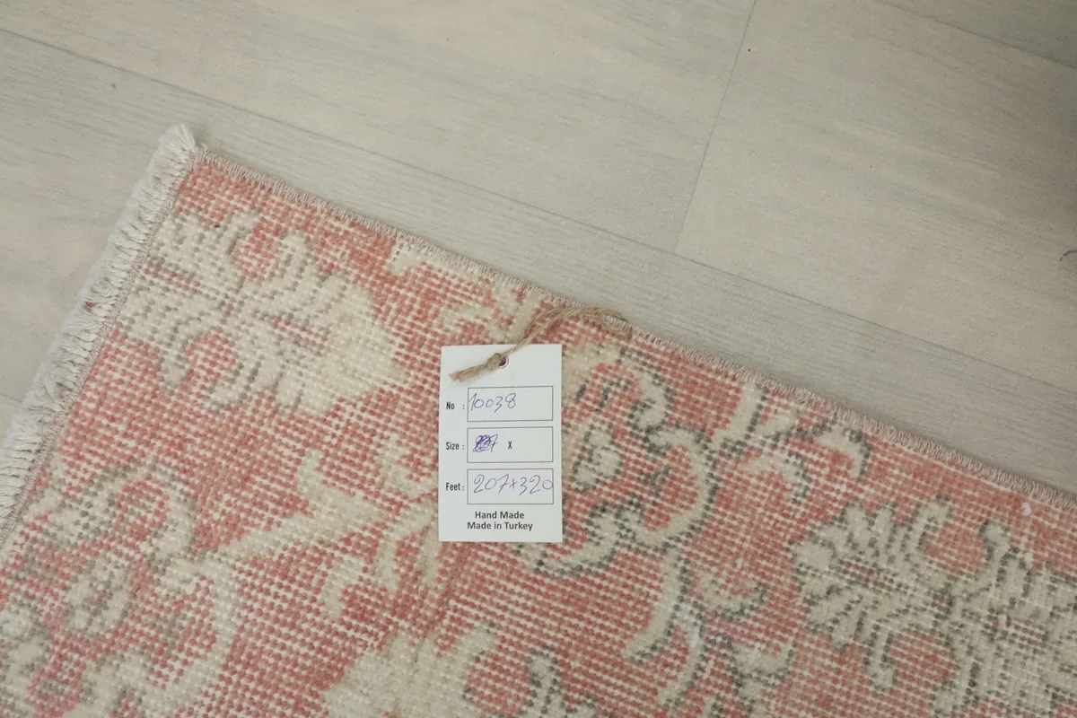 Close-up of the rug's corner with a product tag, indicating its origin and handmade quality