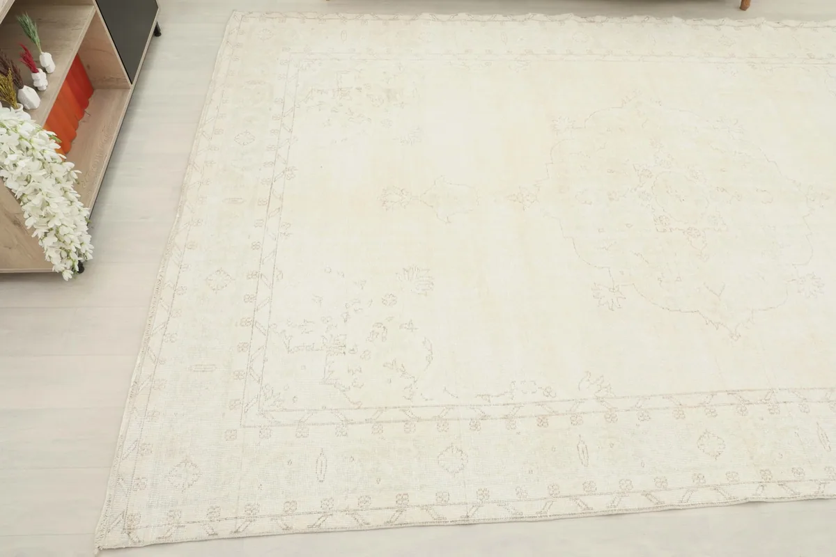 Angled view of the ivory rug from another corner, showing its placement in a room