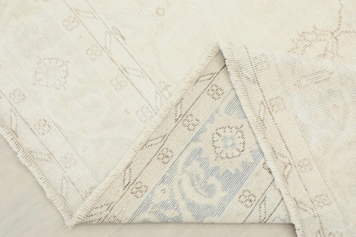 View of the rug's underside, revealing the hand-knotted cotton foundation