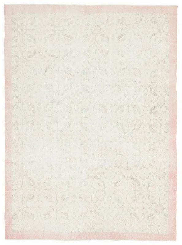 Full overhead view of the 6'11" x 9'11" vintage ivory and rose floral rug on a white background