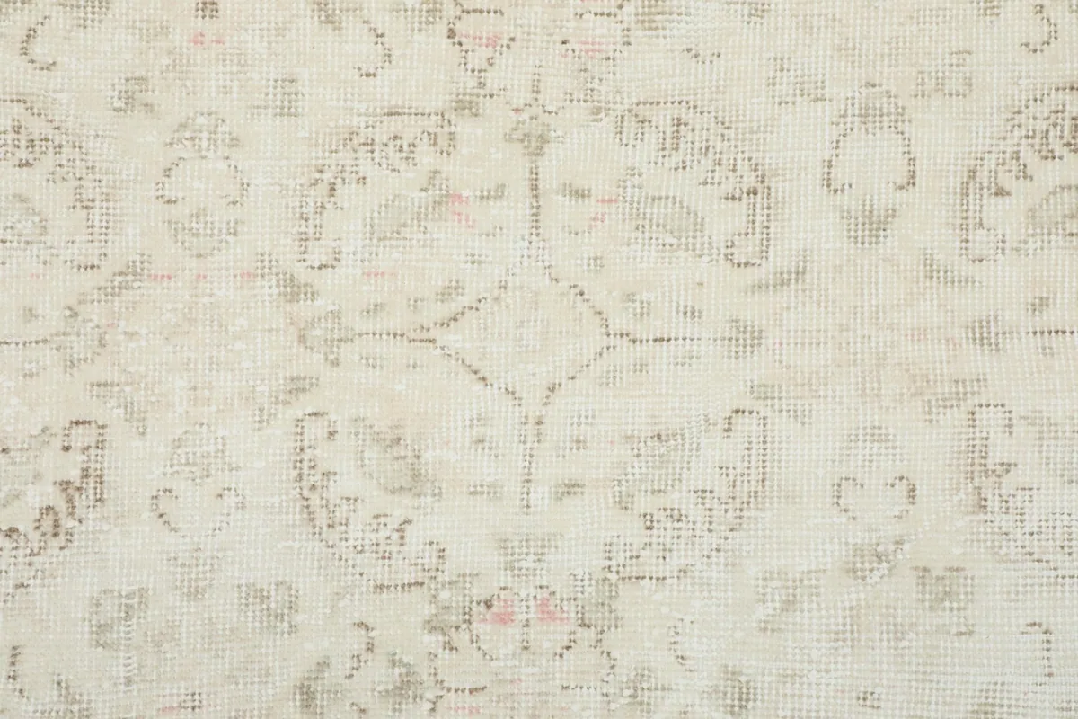 Detailed view of the hand-knotted wool pile, showing the texture and subtle color variations in the pattern