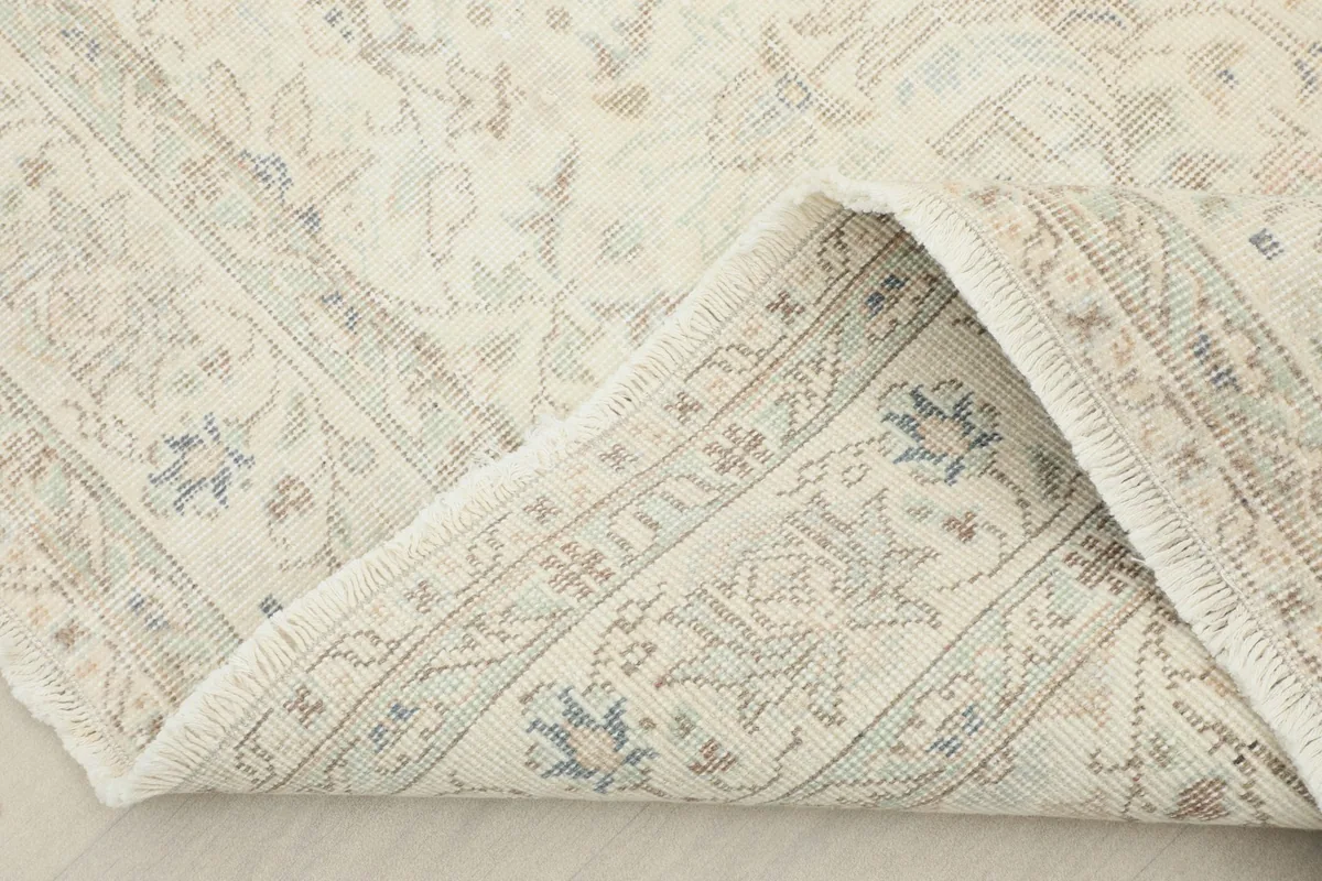 View of the rug's reverse side, showing the cotton foundation and knotting