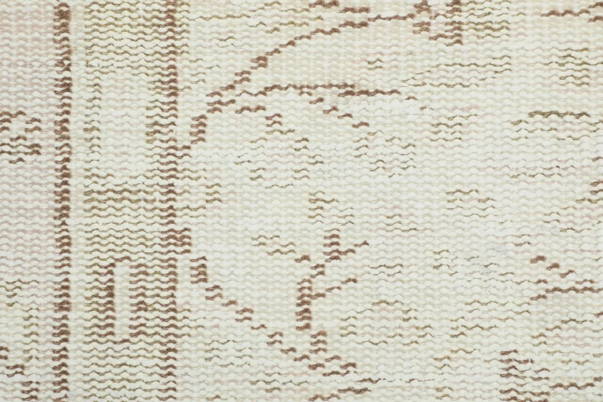 Close-up of the low wool pile, revealing the texture and subtle color variations of the hand-knotted weave.