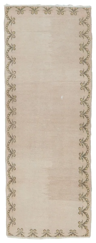 Full overhead view of the beige and olive vintage Anatolian runner rug on a white background.