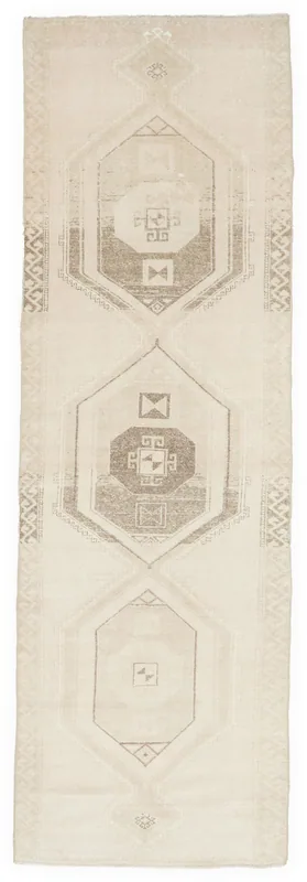 Full top view of a 3'10" x 13'2" beige geometric Anatolian runner rug on a white background