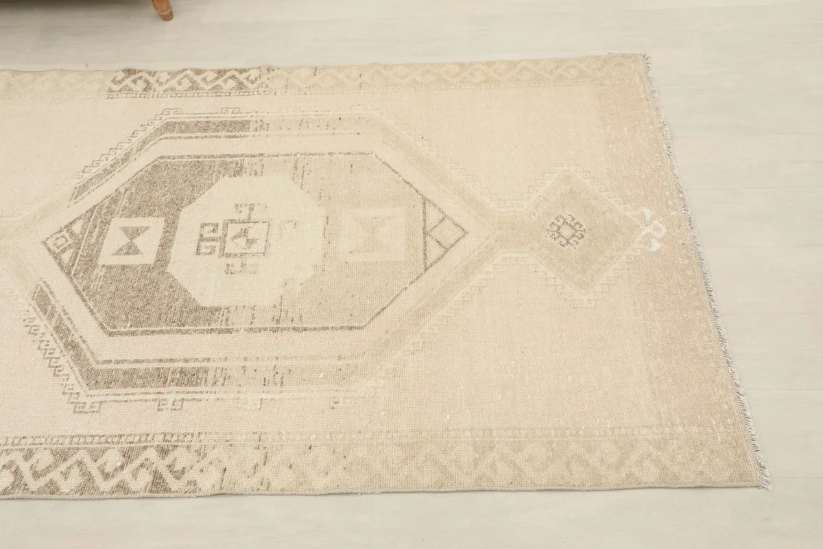 Close-up of the geometric motif in gray and beige on the vintage Anatolian runner