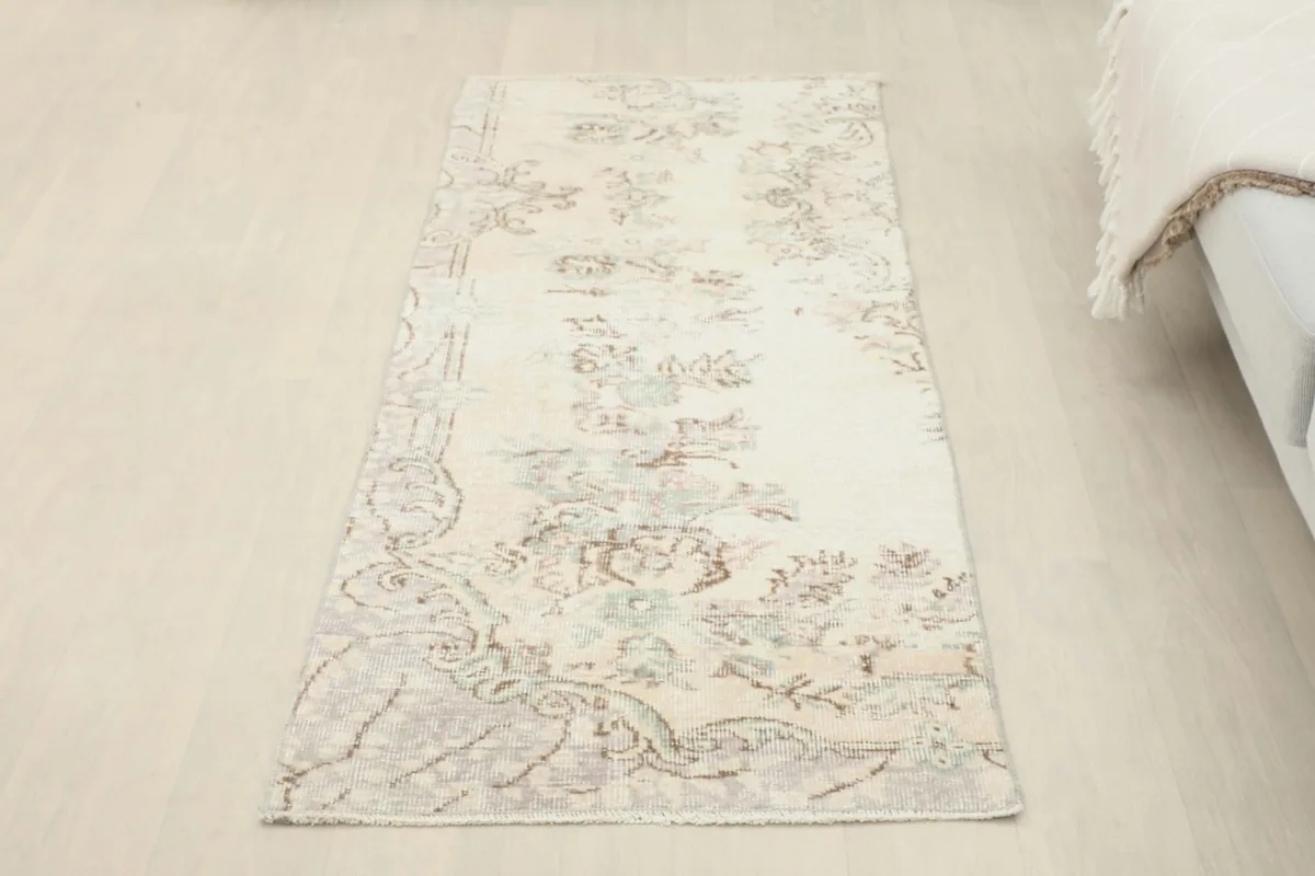 Overhead view of the full ivory floral runner, providing a clear perspective of its overall design and size.
