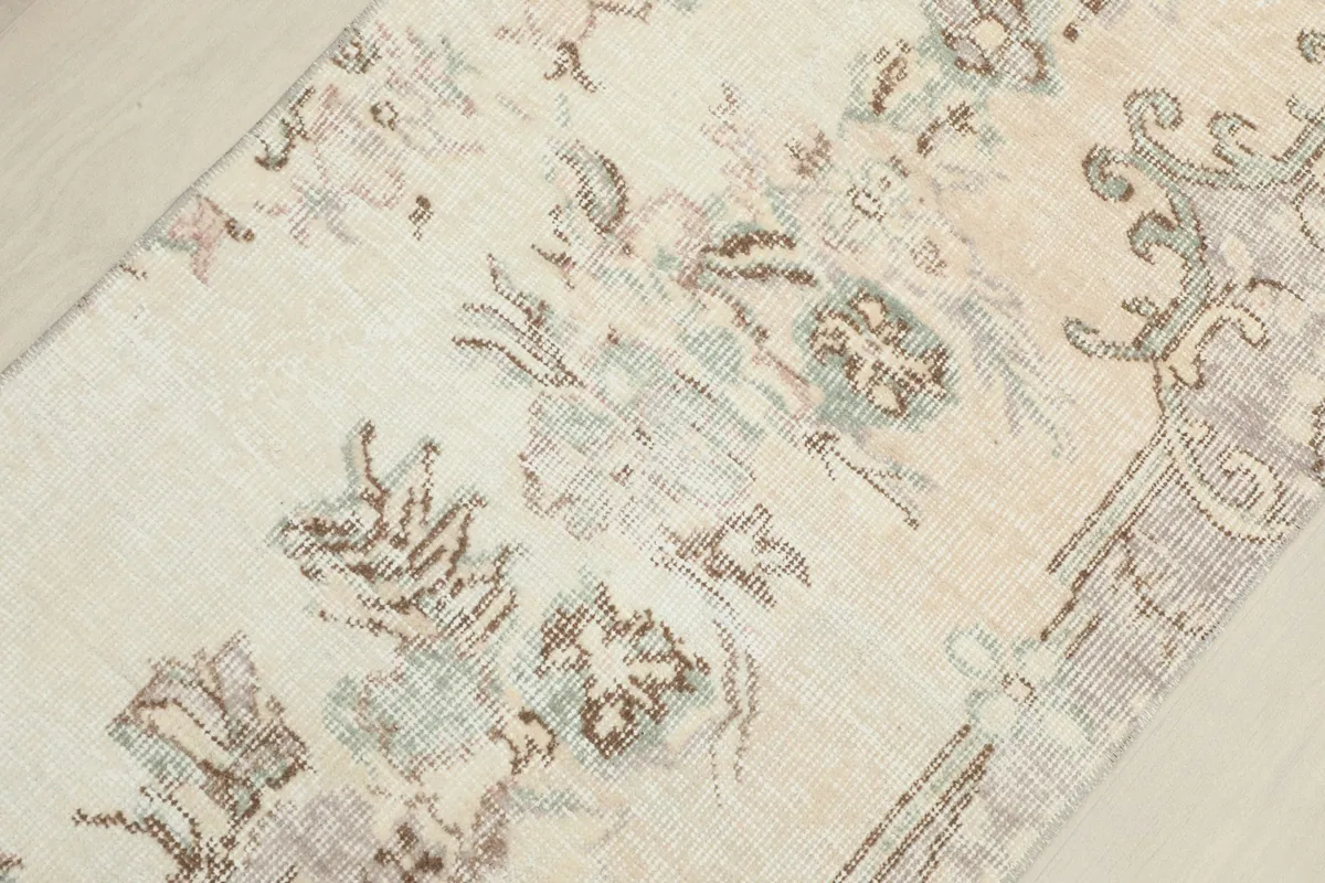 Angled view of the rug's surface, revealing the intricate floral motifs and texture.