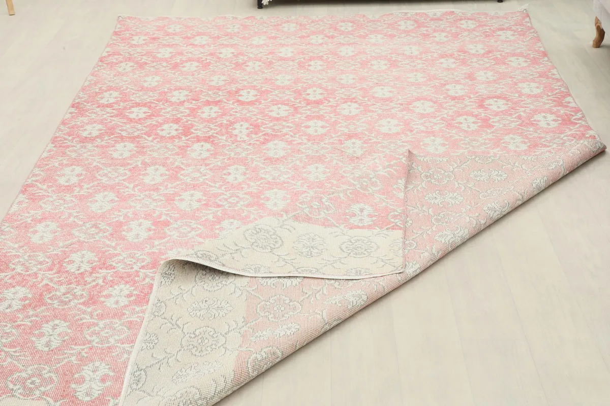 Large fold in the rug, showing the back of the rug and the consistent pattern from the front.