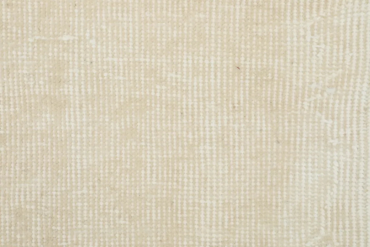 Detailed view of the rug's cotton foundation, showing the hand-knotted construction from the back.