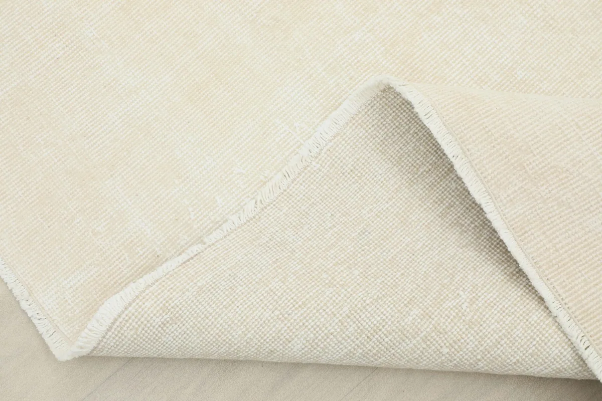 View of the rug folded, revealing the thickness of the material and the soft reverse side.