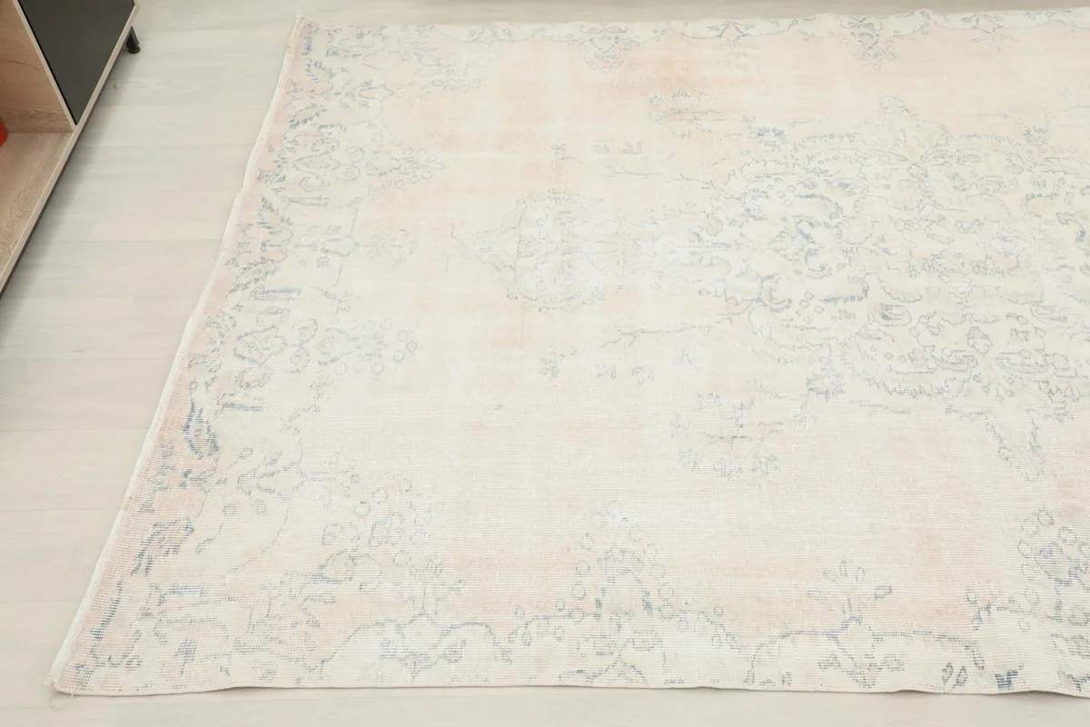 Another angled view highlighting the subtle blue patterns against the cream background