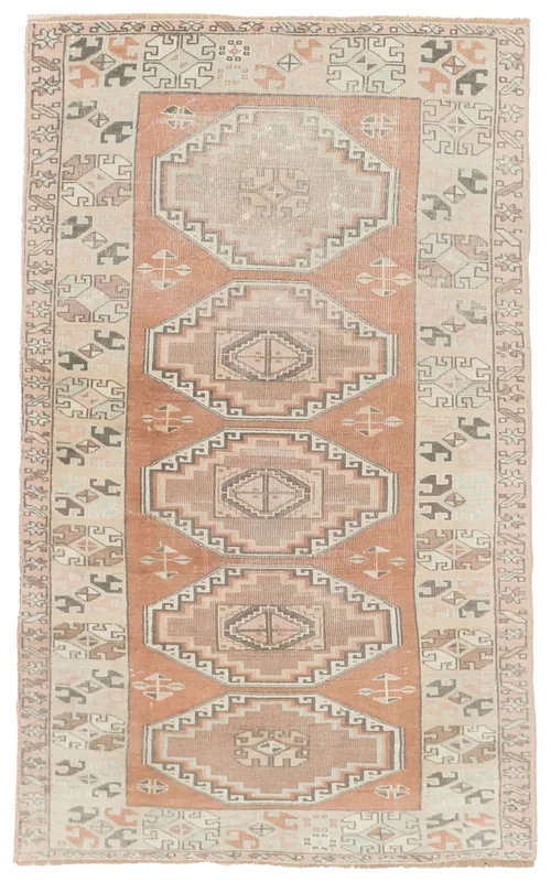 Full overhead view of the rust and beige tribal geometric vintage rug
