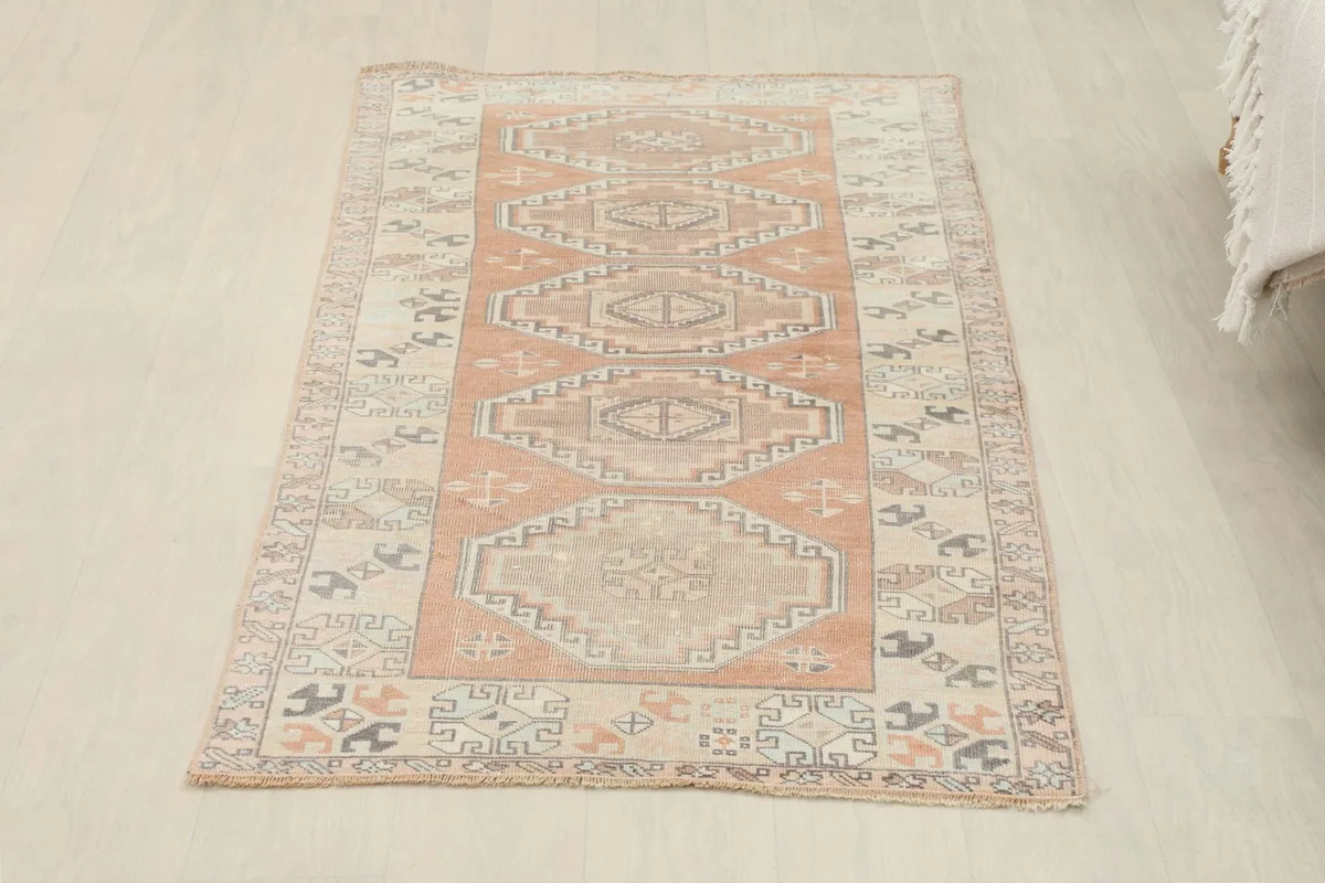 Full overhead view of the vintage rug, showing its overall shape and design