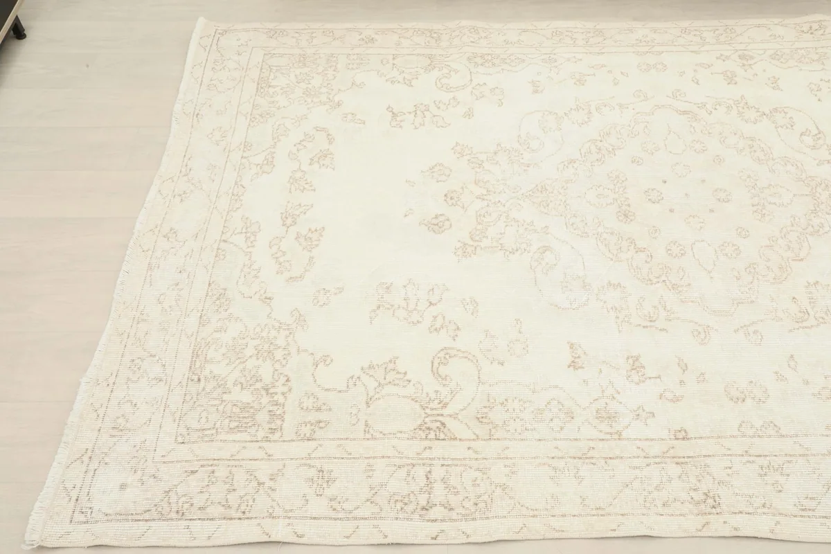 Angled view of the rug's opposite corner, revealing the gentle color variation and low pile texture.