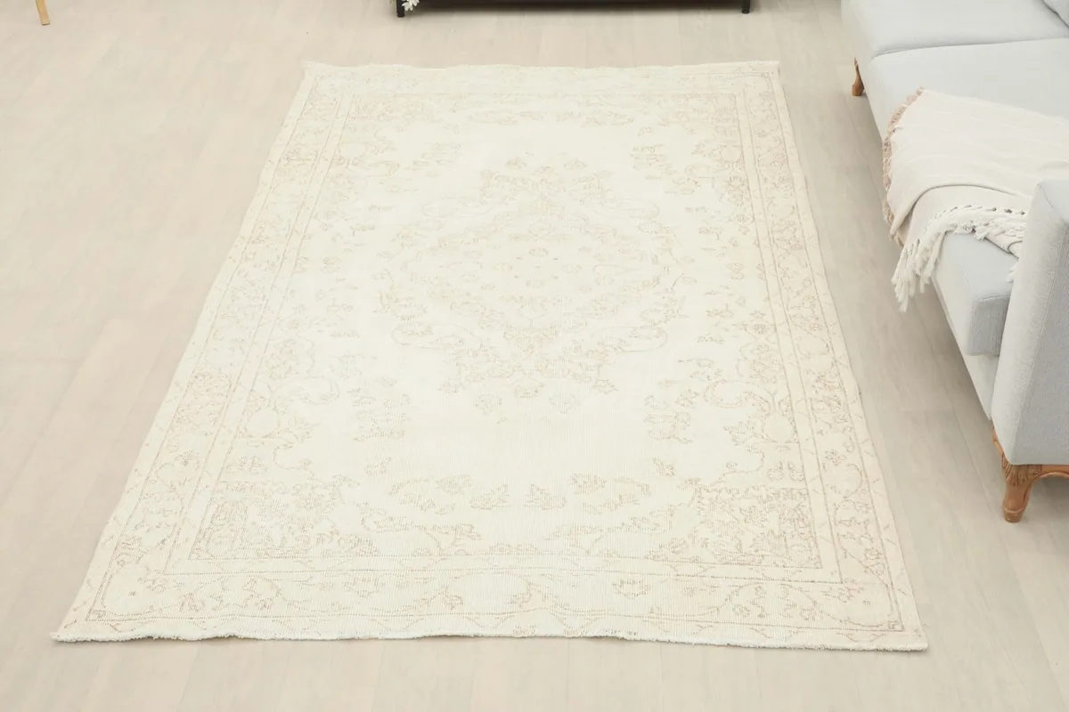 Full view of the ivory tonal medallion rug in a room, offering a sense of its scale and presence.