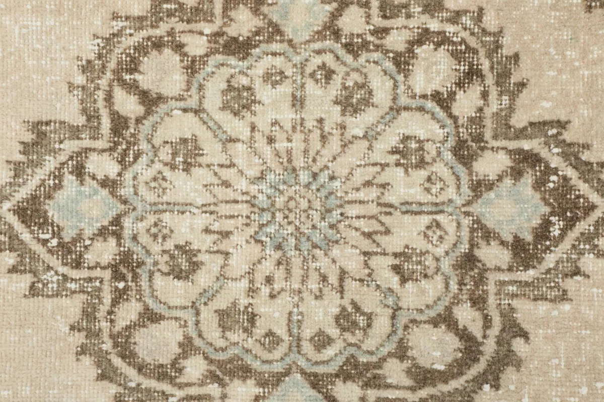 Close-up of a single medallion, revealing the intricate patterns and wool texture.