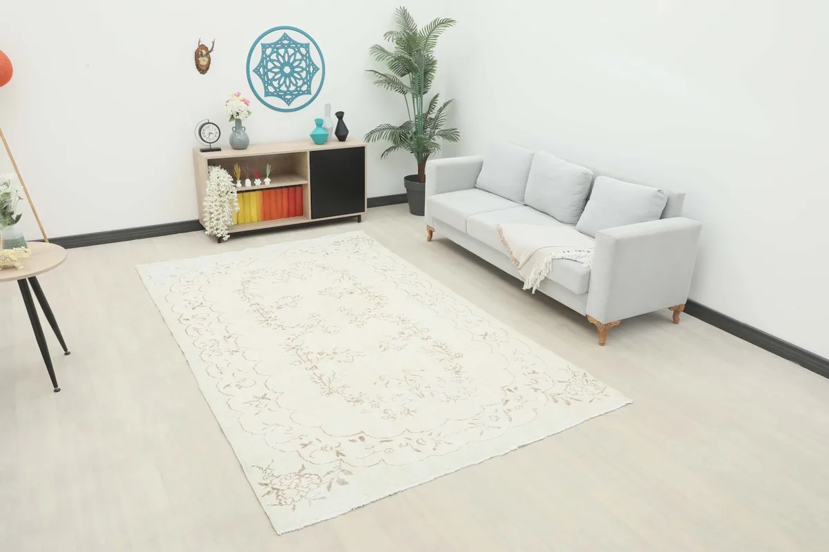 Ivory beige floral vintage rug displayed in a bright living room setting