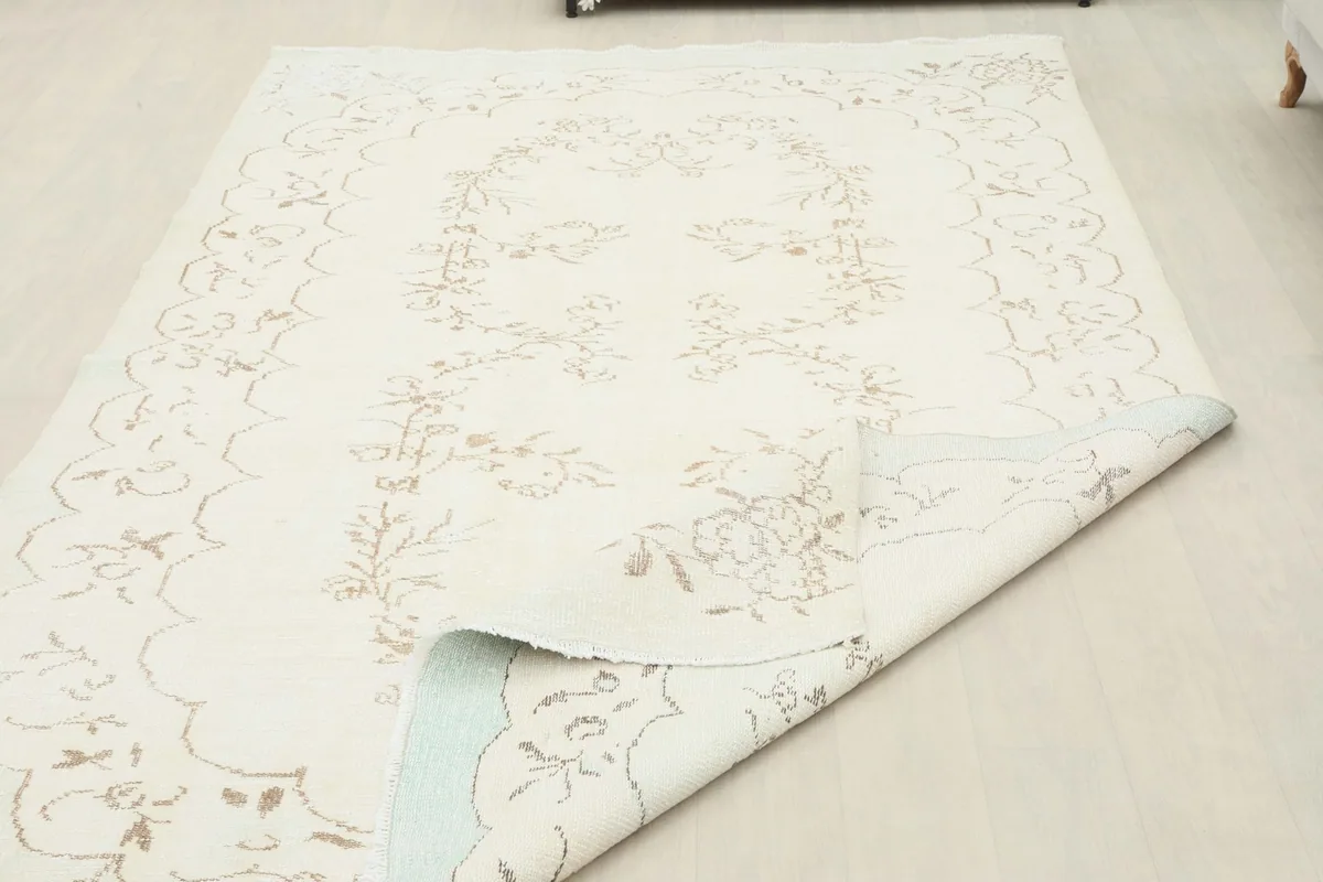 Rug corner folded back, revealing the backing and pile thickness