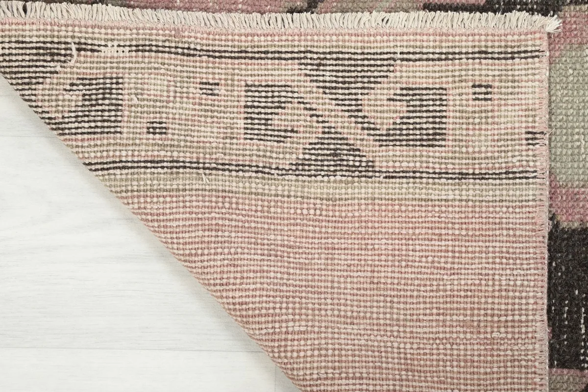 Underside view of the hand-knotted cotton foundation and the back of the wool pile
