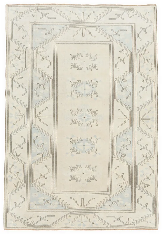 Full top view of the 6x10 vintage Anatolian rug with ivory field and blue geometric patterns