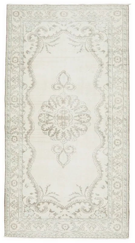 Full overhead view of the ivory and tan medallion vintage Anatolian rug