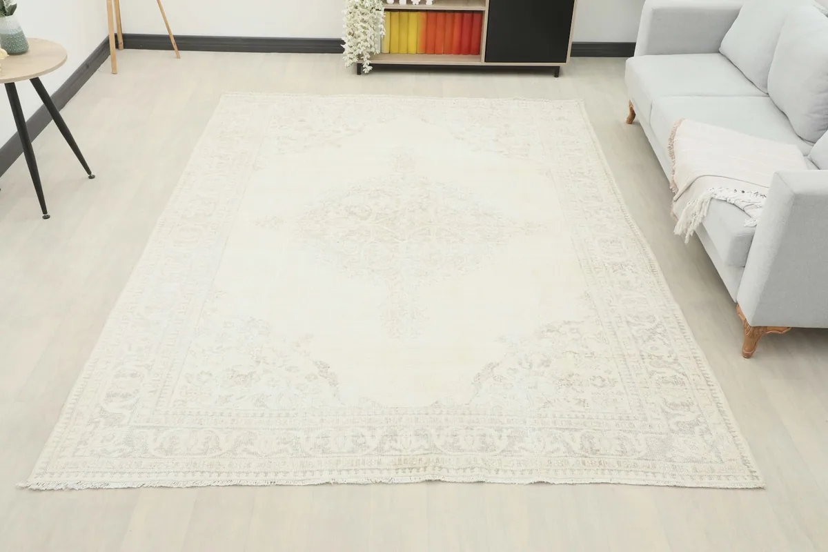 Wide shot of the ivory and gray rug in a room, showing its full scale and placement