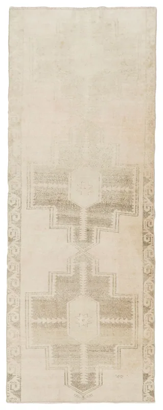 Full top view of a beige and gray geometric vintage runner rug on a white background.