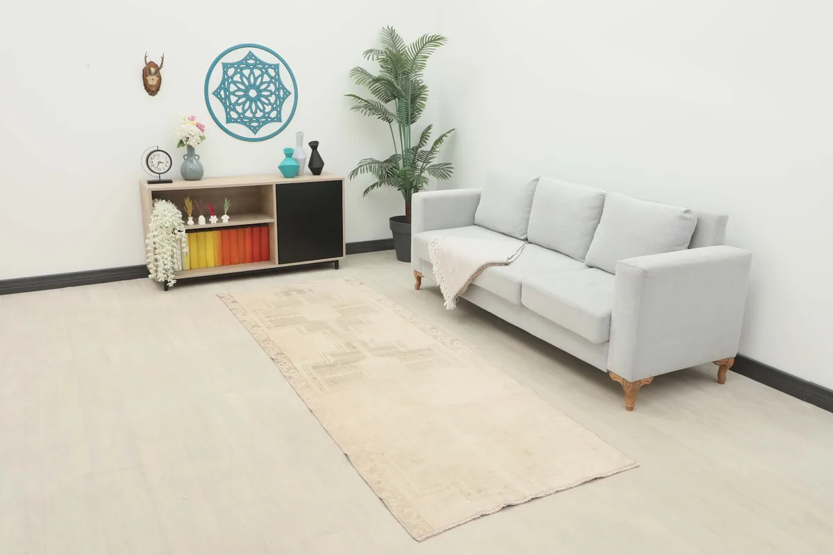 Vintage runner rug in a modern living space with a light gray sofa and minimalist decor.