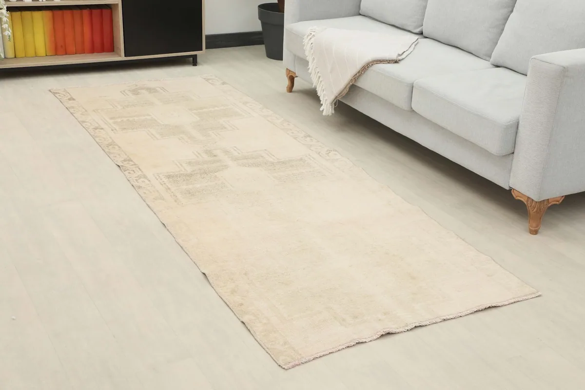 Angled view of the beige and gray runner rug extending along a modern room's floor.