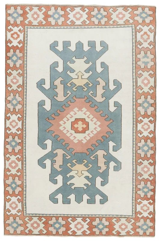 Full top view of the ivory, blue, and rust vintage Anatolian rug with tribal medallion