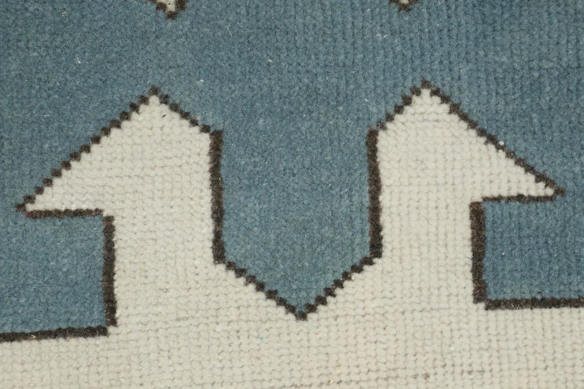 Close-up of the low wool pile and hand-knotted texture of the rug