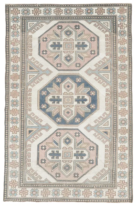 Full top view of the cream, blue, and rose geometric Anatolian rug on a white background