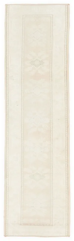 Full overhead view of the 2'8" x 9'7" cream vintage Anatolian runner rug on a white background.