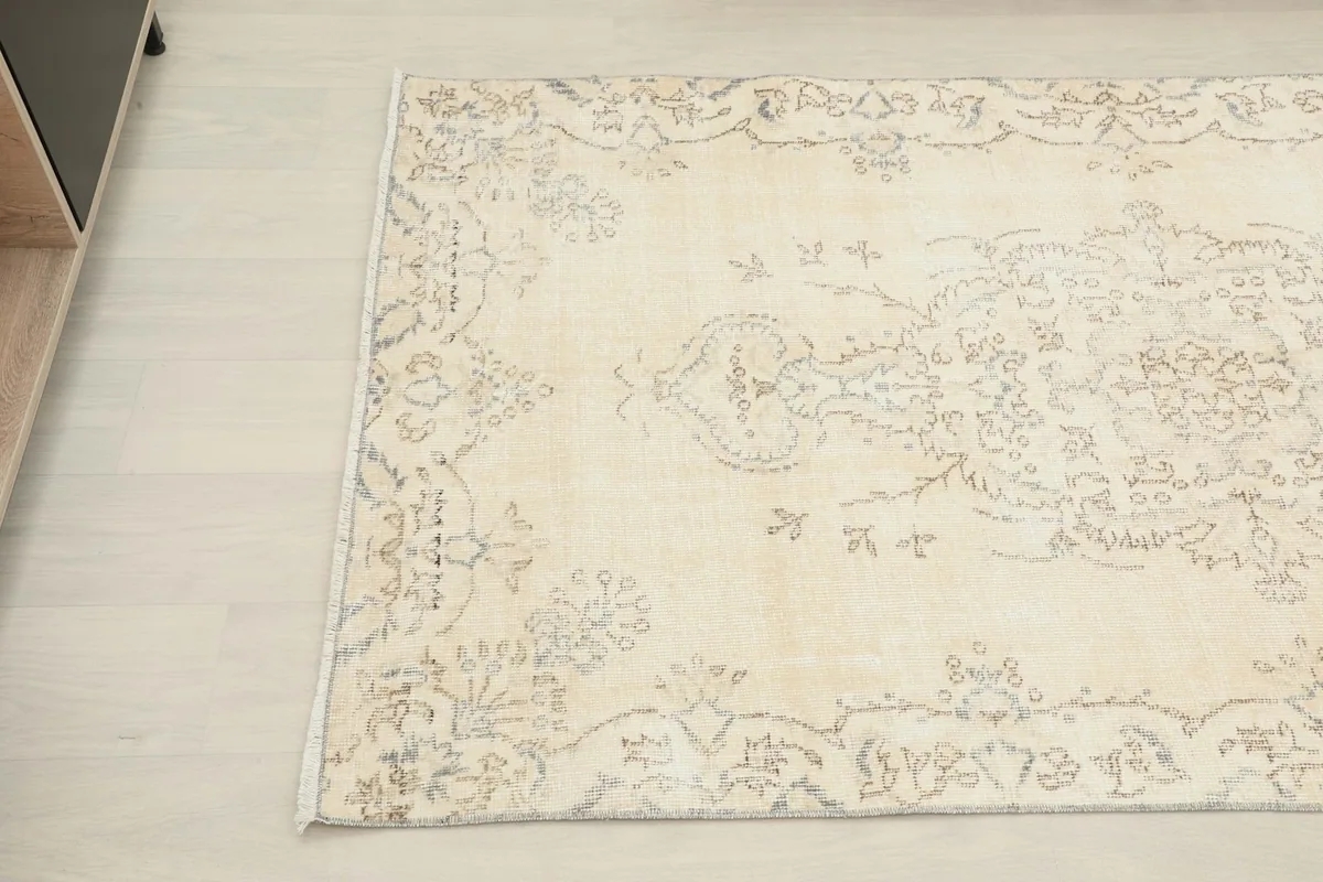 Detail view of the rug's central medallion and surrounding faded motifs