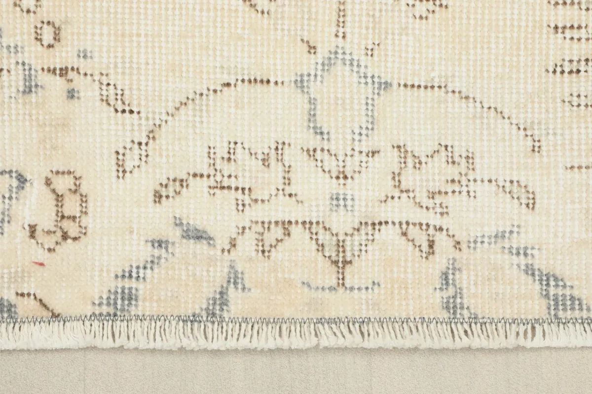 Close-up of the rug's low pile and fringe, showing the hand-knotted texture