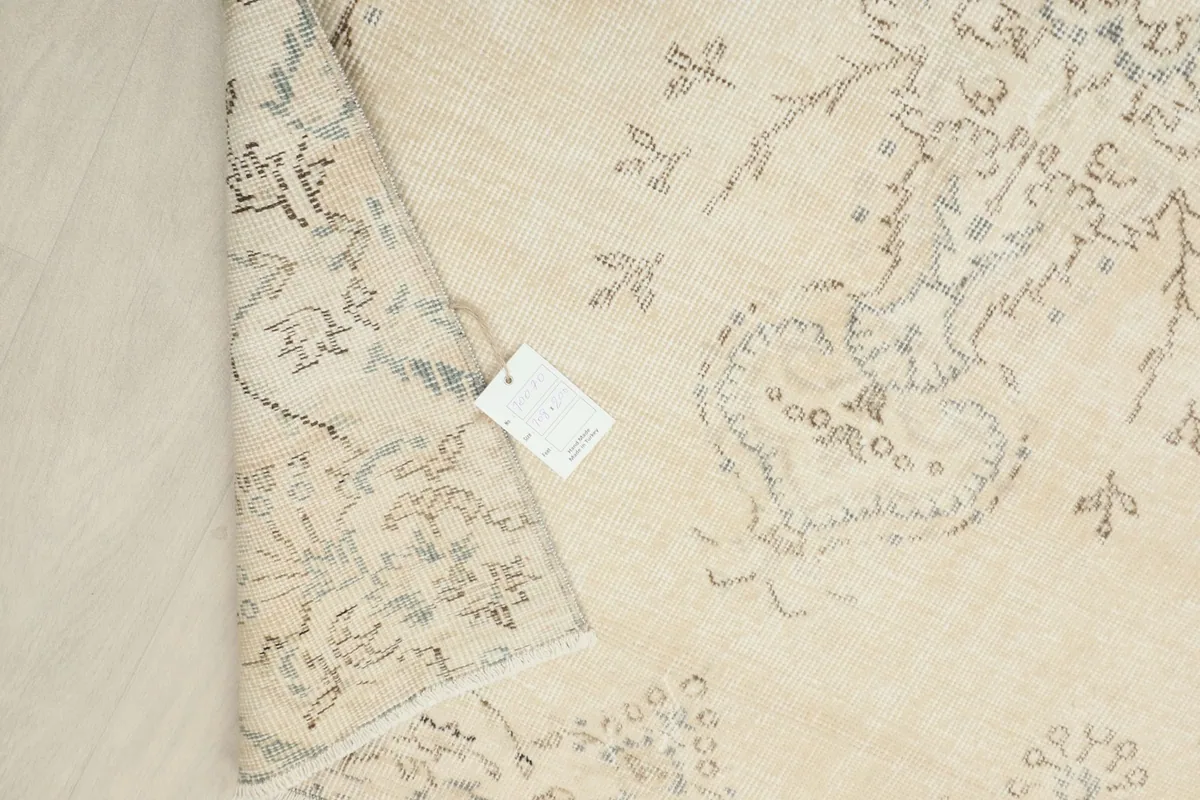Close-up of the rug's reverse side, displaying the tag and knotting structure