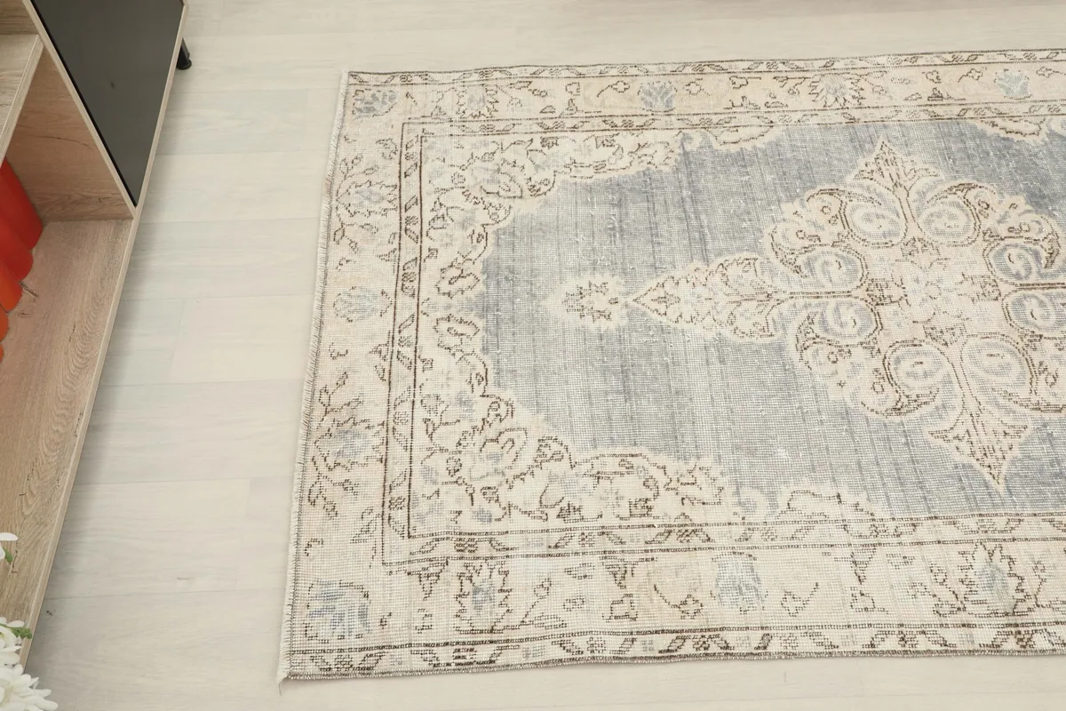 Overhead angle capturing the intricate patterns and colors of the hand-knotted vintage rug