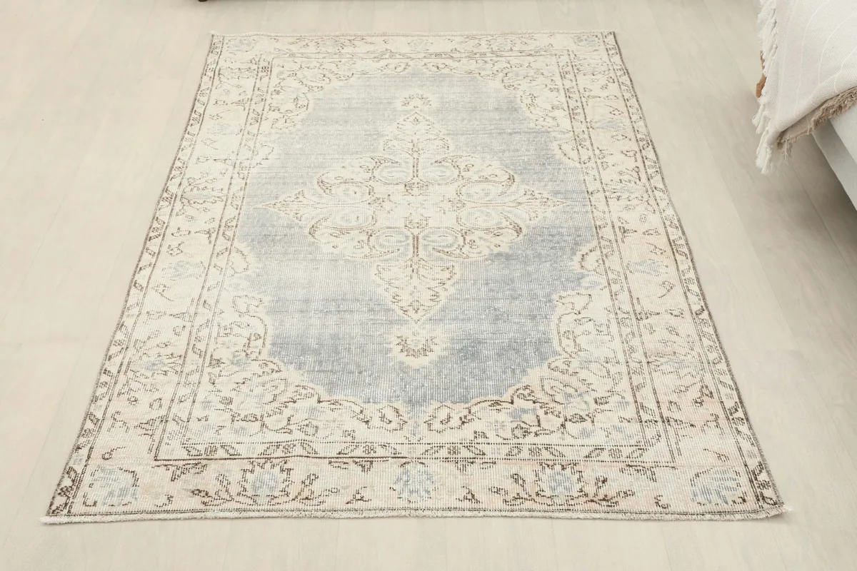 Full overhead view of the vintage Anatolian rug from a slightly elevated perspective in a room