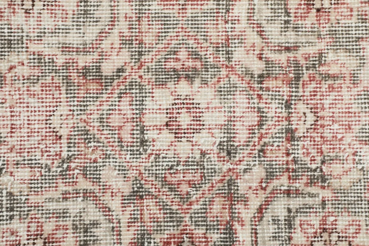 Close-up of the hand-knotted wool pile, showing the texture and color variations of the vintage rug